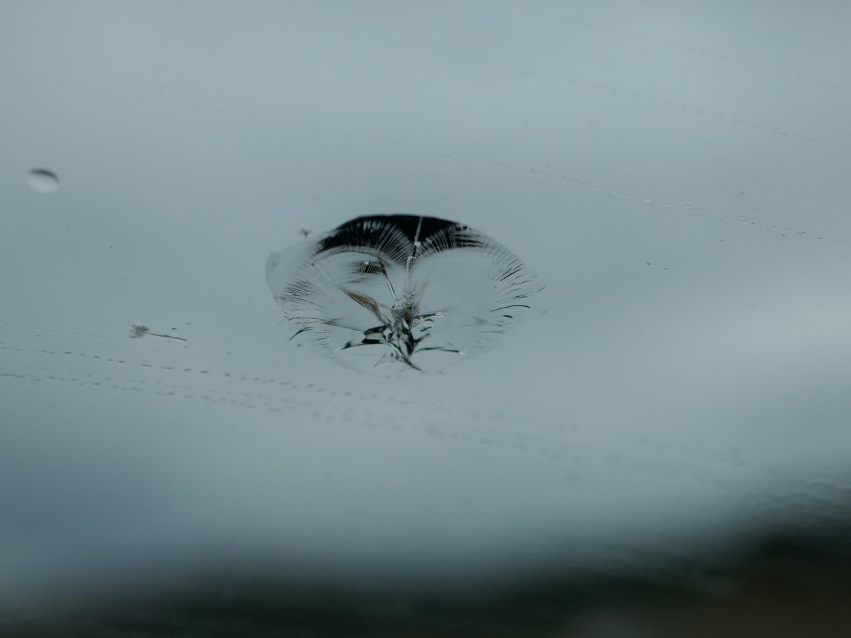 Close-up of a stone chip in a car windscreen